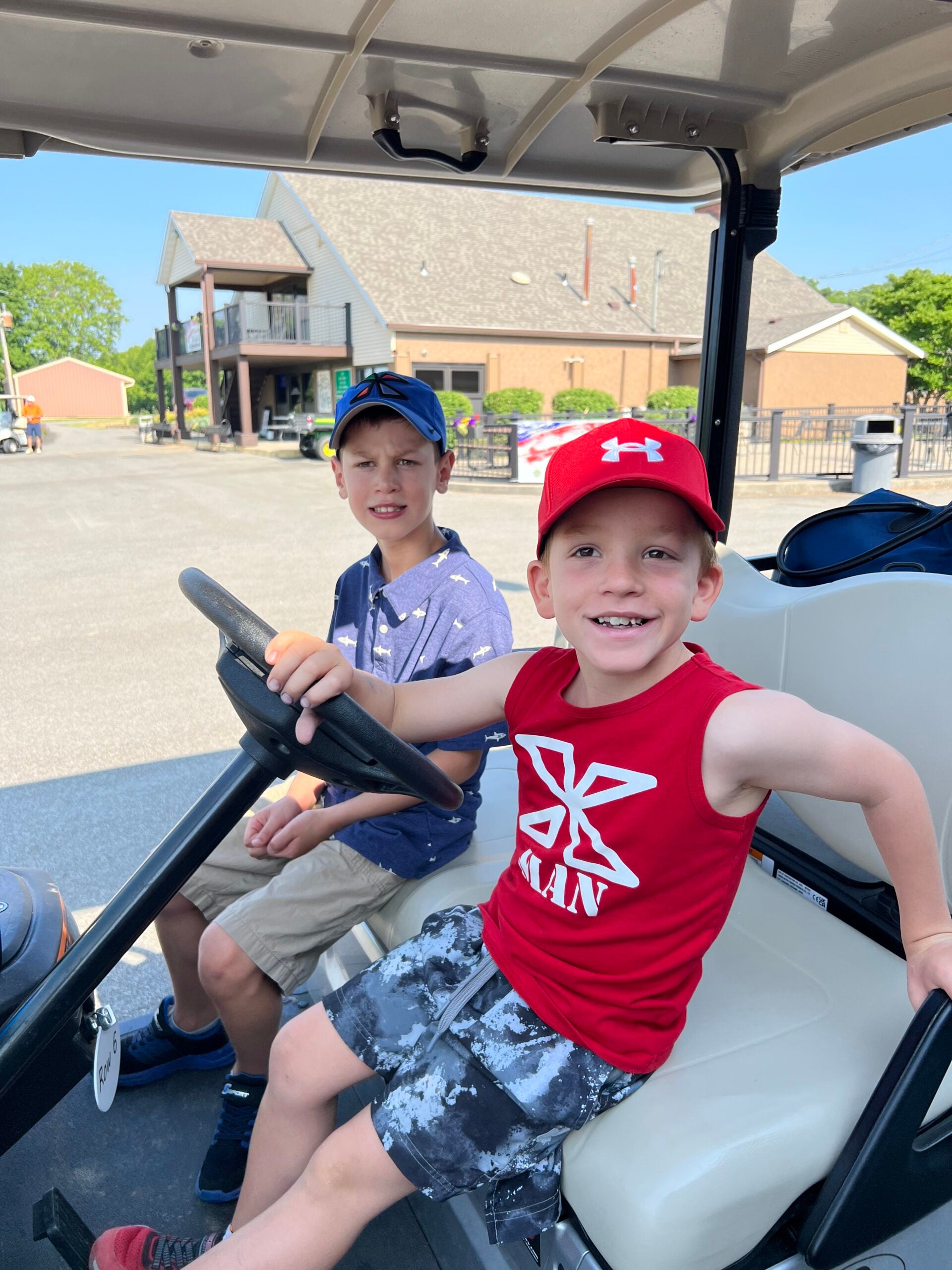 Kids driving the golf cart