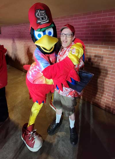 Jason Fishman, an adult with Fragile X syndrome, hugging the St. Louis Cardinals mascot.