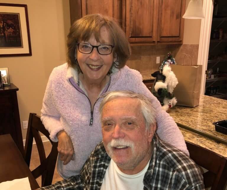 Kathy Menke and her husband who has FXTAS, in their kitchen at home.