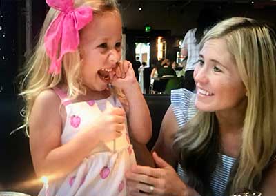 Mother and daughter, Katy and Gwynn Merrill, laughing together.