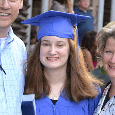 Young girl in blue graduation gown