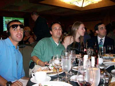 Matt Carpenter at left, a young man with Fragile X syndrome, out to dinner with a group of friends.