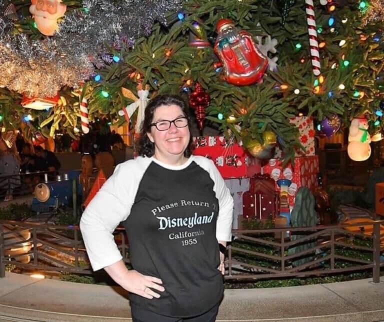 Missy Zolecki in front of a huge Christmas tree.