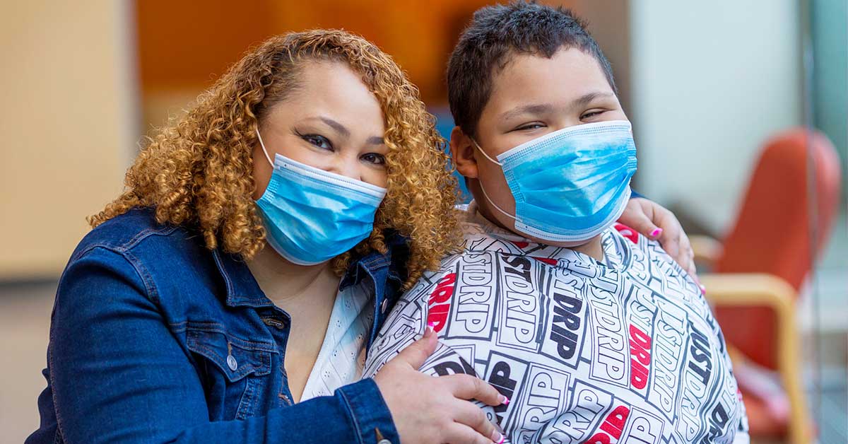Mother and son wearing medical masks.