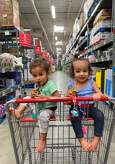 Twins Nathan and Natalia in mom's shopping cart.