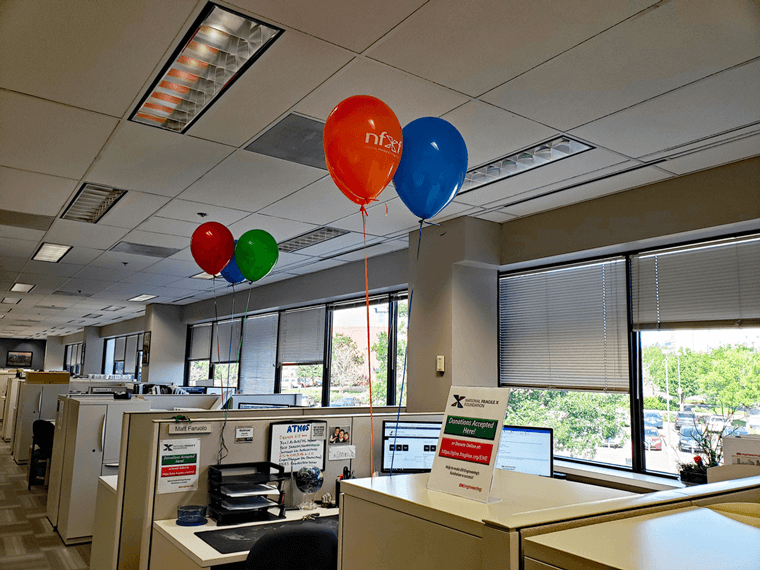 Helium NFXF balloons tethered to cubicle walls and file cabinet