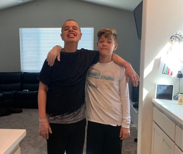 Reuben with his brother in their family's kitchen.