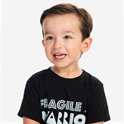 A young boy with Fragile X syndrome wearing a black t-shirt.