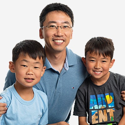 A father with his two sons, one of which has Fragile X syndrome.