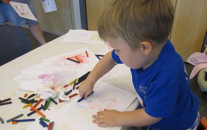 Boy using crayons
