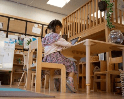 Female child working at a table in a library