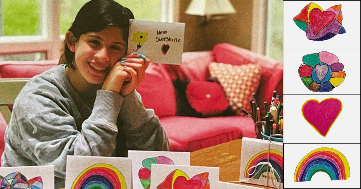 Charlye holding one of her homemade Valentine's Day cards, with more laid out on a table.