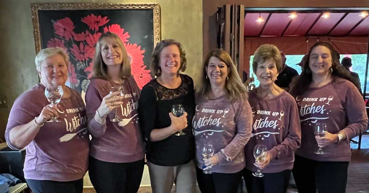 Six women enjoying a wine-tasting at the Western Massachusetts chapter Cork & Cafe event and fundraiser.