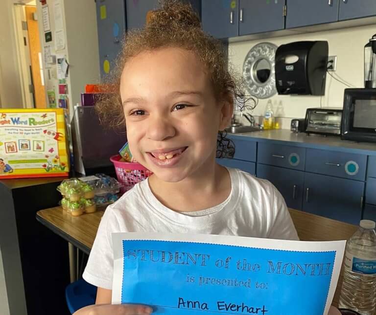 Anna Everhart holding her "Student of the Month" certificate